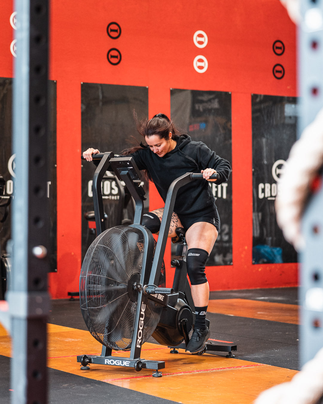 Hyrox female athlete performing the air bike