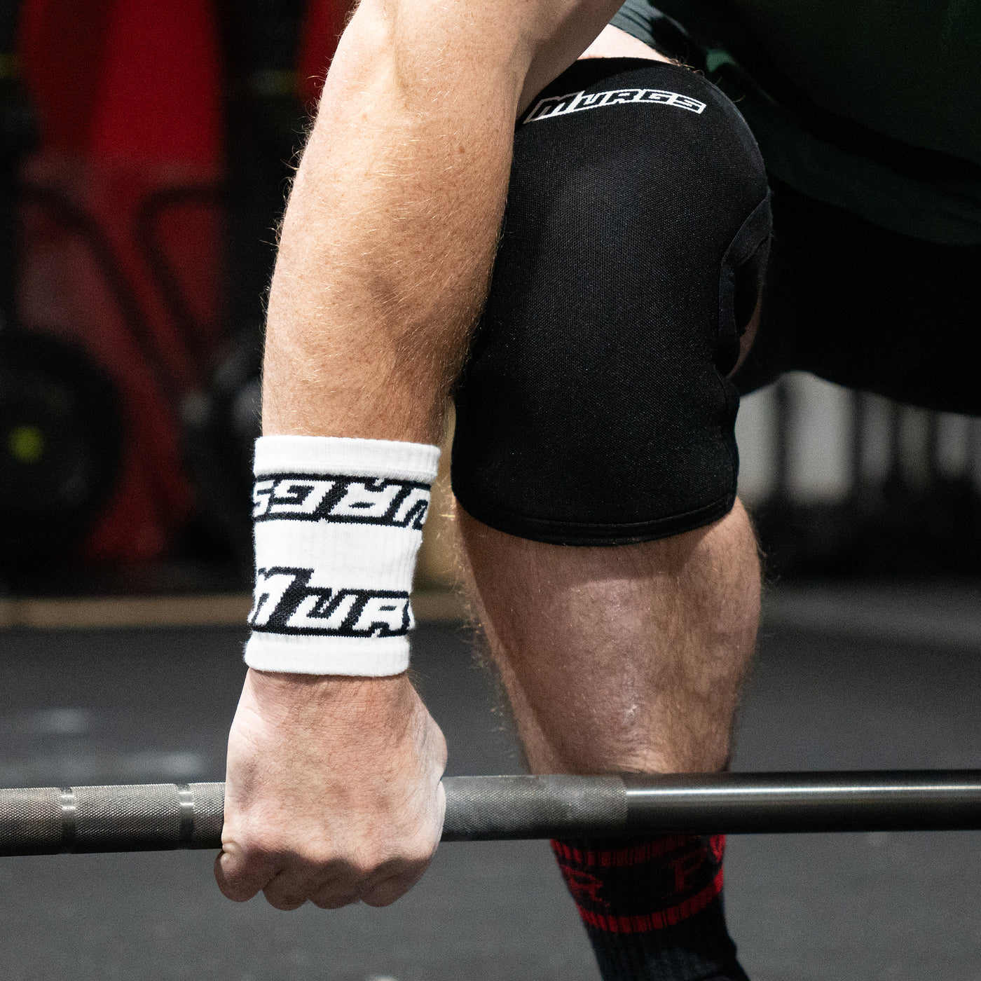 Athlete in white murgs wristbands during crossfit