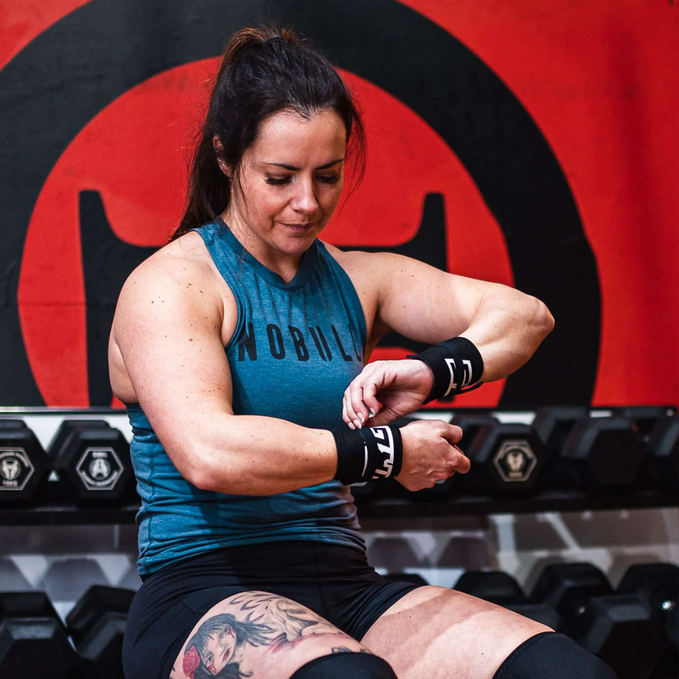 Female CrossFit athlete tying Murgs cotton wrist wrap