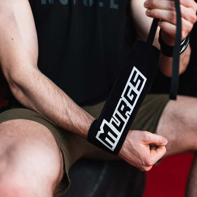 Male CrossFit athlete tying Murgs cotton wrist wrap